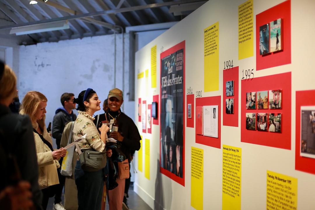 People looking at images on display in an exhibition at a film festival