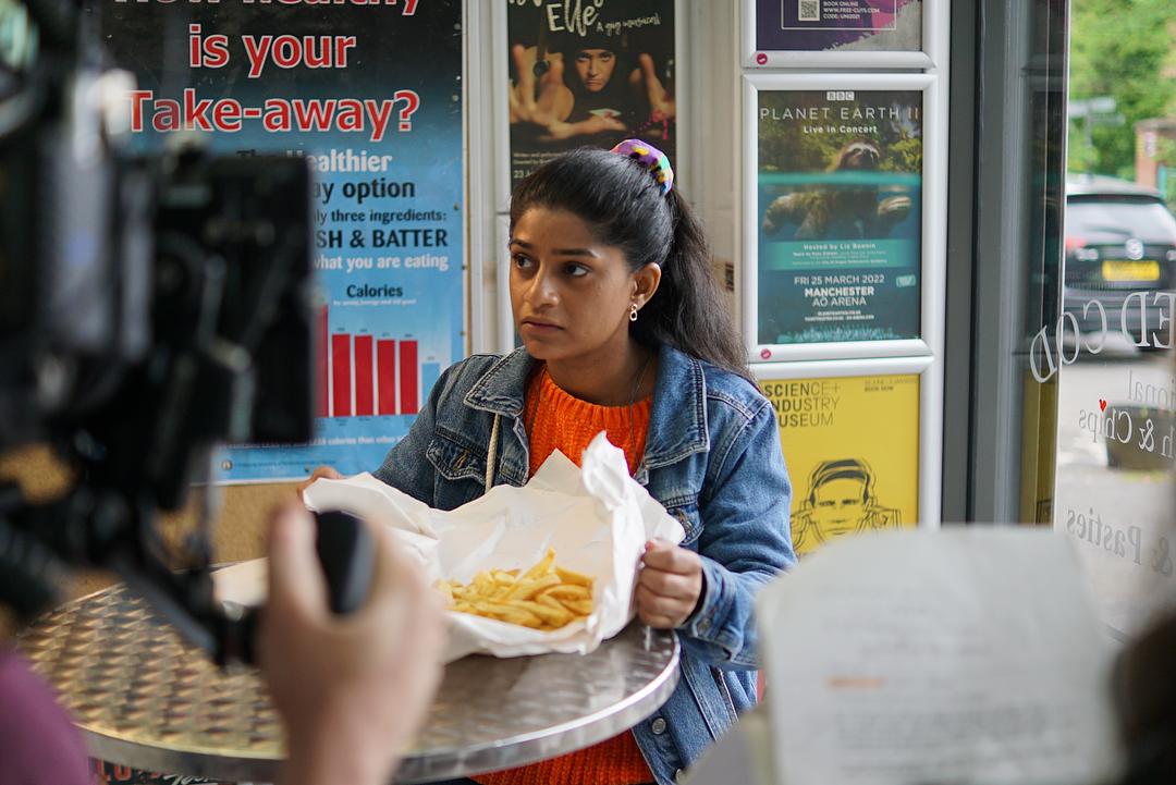 Haiesha Mistry holding takeaway container of chips