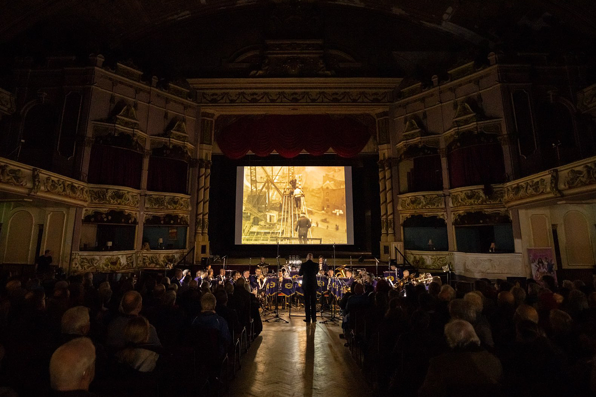 A screening of film in a cinema with a live score