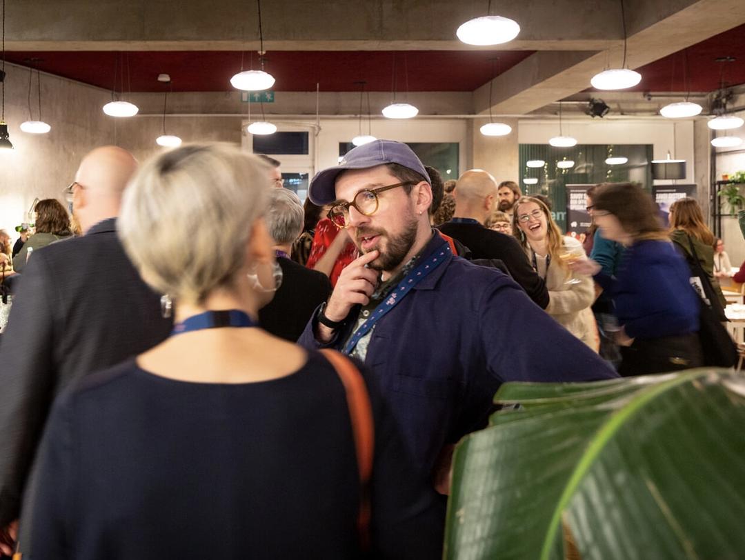 A group of people talking and drinking