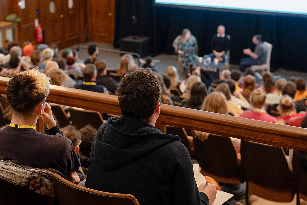 A filmmaker takes notes during an In Conversation event with Paul Abbott and Sean Conway