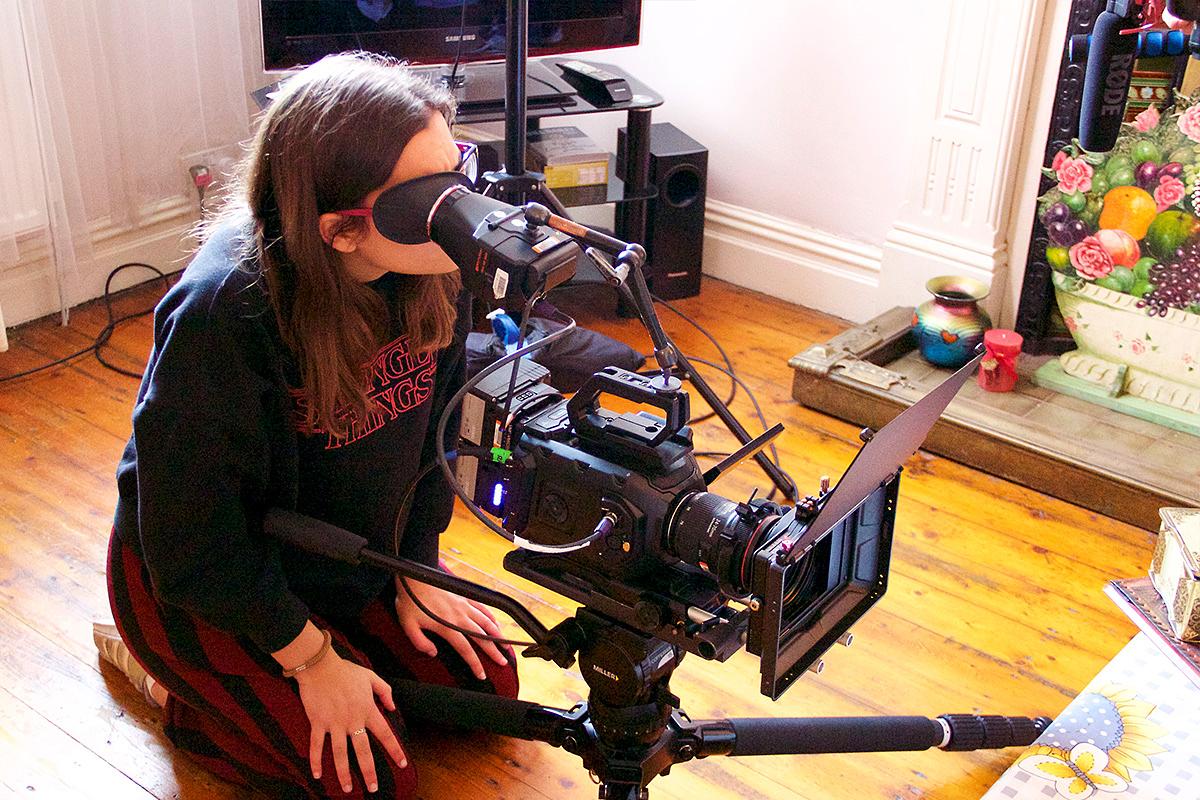 A filmmaker composes a shot as part of HOME's BFI Film Academy Short Course