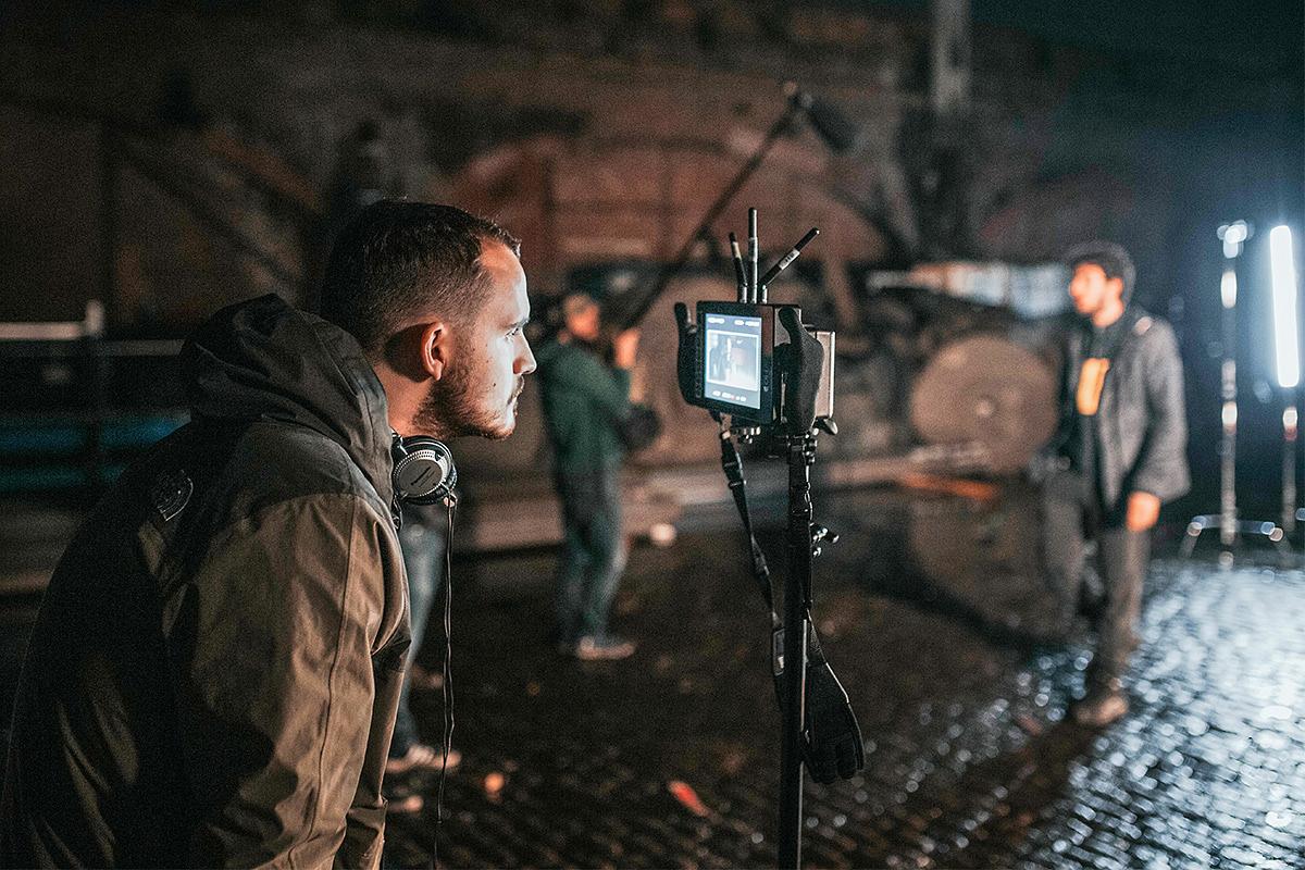 Jack Benjamin Gill watches a take during the shoot for DOGGERLAND