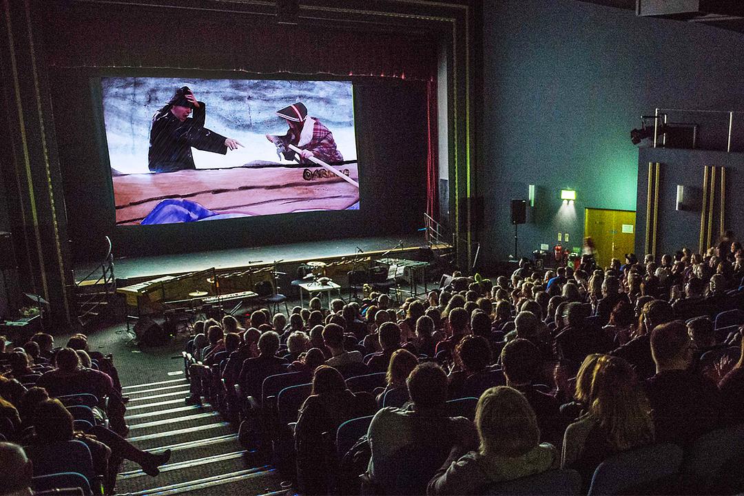 A busy cinema audience enjoy a Beacon Films screening