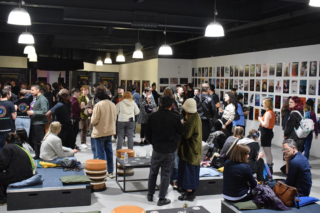 Participants at Bolton Film Festival gathered together, some sitting.