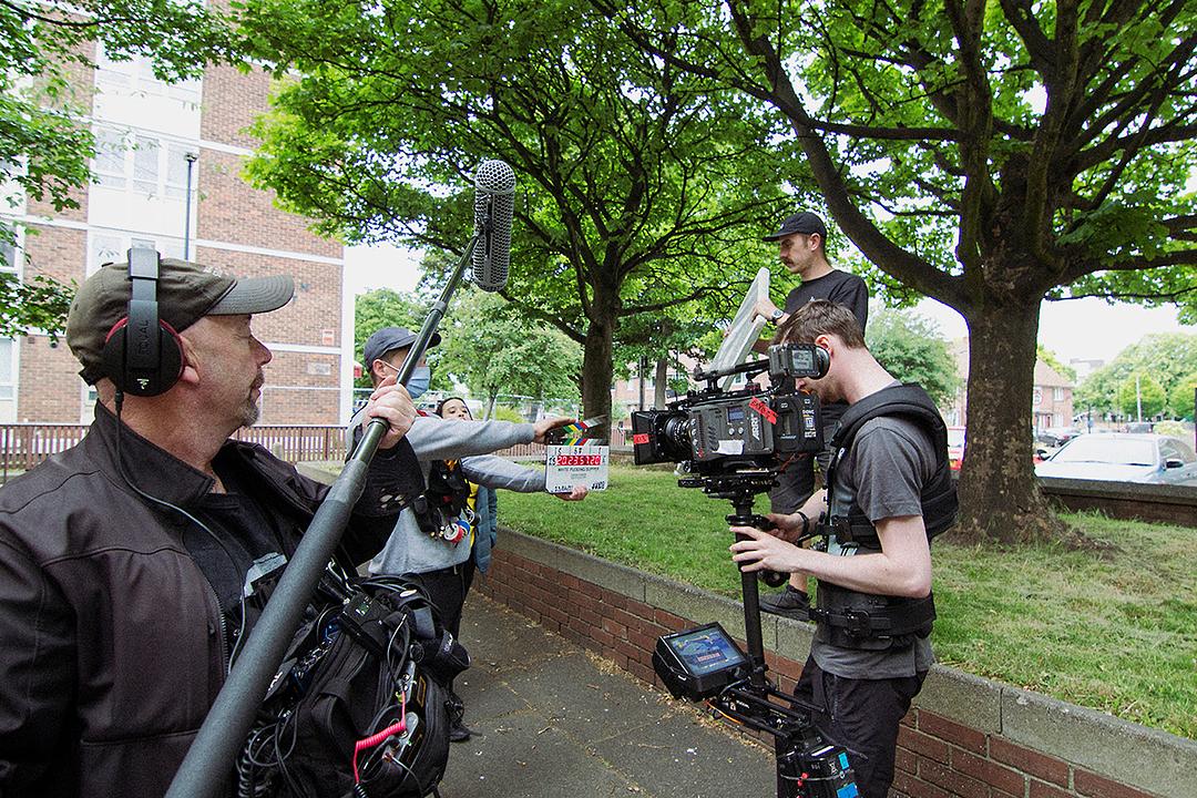 The crew prepare for a take on a location shoot for WHITE PUDDING SUPPER