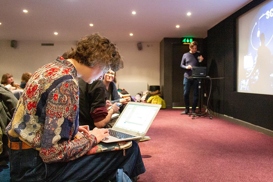 A delegate works on their laptop during a Film Hub North event at Tyneside Cinema